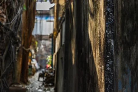 The light that shines down at the wall of narrow street in the old village. Stock Photos