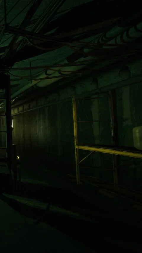 Light shines on metal pipes in dark hall in industrial setting at night Stock Footage 339952829