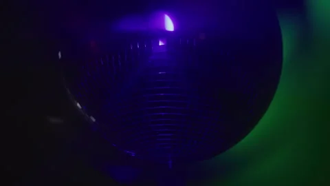 Light Shines Off Spinning Fast Disco Ball Turning Colors At Night Stock Footage 270403613