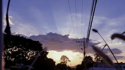 Light shines through the clouds and the treetops Stock Footage 260387878