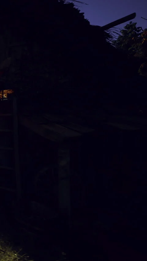 Light shines through a dark area in an old building with a ladder Stock Footage 334306880