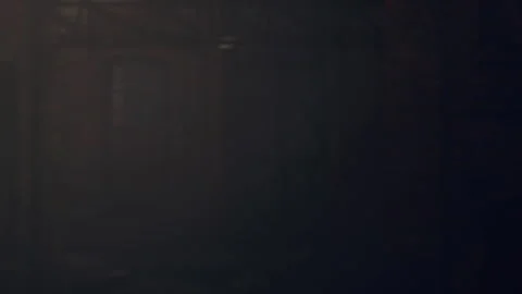 Light shines through a dark space revealing textures and shapes Stock Footage 340233104