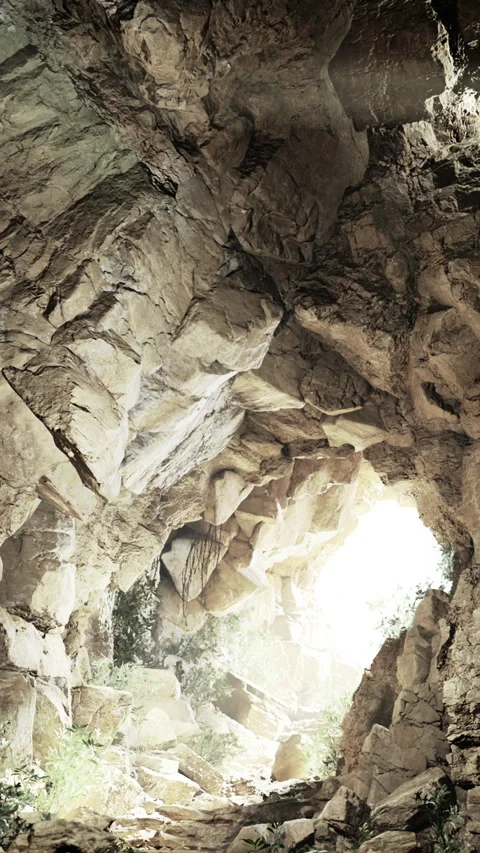 Light shines through a rock cave with plants and sunlight in the background Stock Footage 331750361