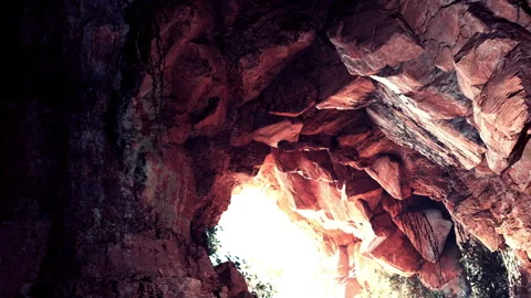 Light shines through rock formation in cave at midday Stock Footage 344099009