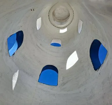 Light shines through windows of lighthouse tower revealing bright blue sky .. Fotos de archivo