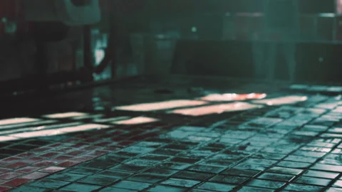 Light shines on wet tiles in an empty room with shadows and reflections Stock Footage 345004689