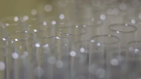 Light shining on glass test tubes in science lab Video stock 104077452
