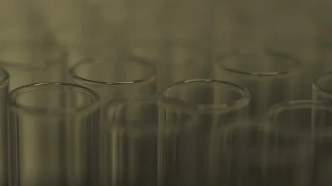 Light shining on glass test tubes in science lab Stock Footage 104077627
