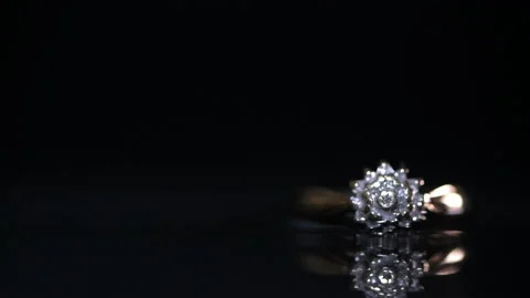 Light Shining Over Gold Diamond Engagement Ring Stock Footage 140759488