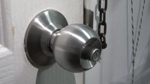 Light shining on silver door knob handle indoor. Video stock 311966384