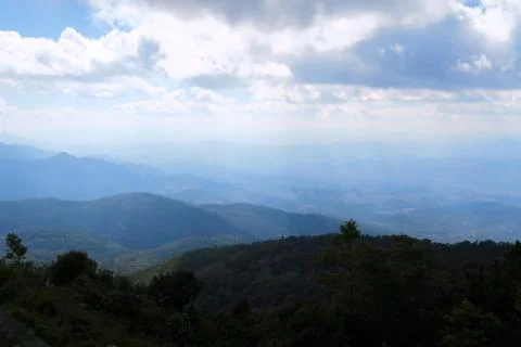 Light shining through the clouds on the mountains Stock Photos