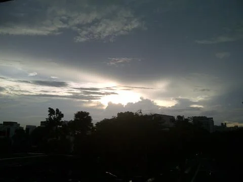 Light shining through dark clouds Stock Photos