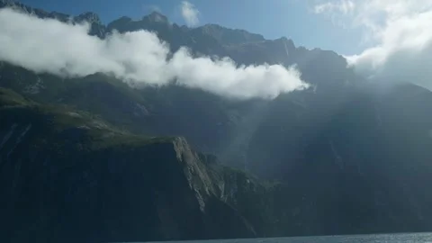 Light shining through mountain at Milford Sound Stock Footage 260850332