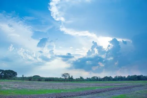 The light shone through the gray clouds before the rain. Stock Photos