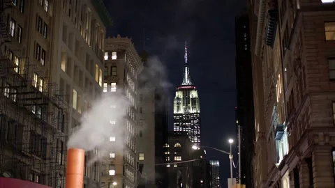 Light Show on Empire State Building in NYC while Steam is escaping Stack. Stock Footage 147977052