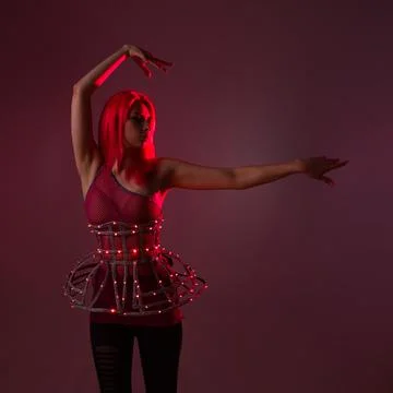 Light show, suit with LEDs. Young beautiful woman in a luminous suit Stock Photos