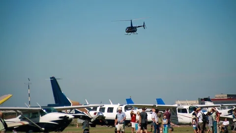 Light small aviation. helicopter flies over the airfield and people. Flying club Stock Footage 101062371