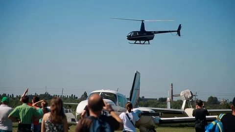 Light small aviation. Helicopter flies over the airfield and people. Flying club Stock Footage 101062400