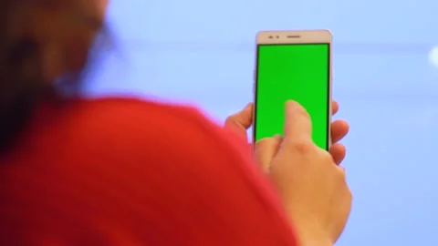Light smartphone with green screen in woman's hand 4K Video stock 102434177