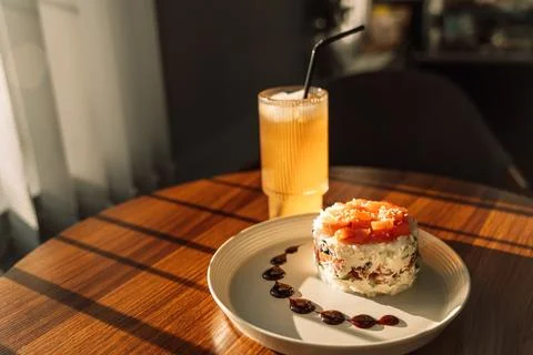 Light snack of red fish on a round plate with a cool drink Stock Photos