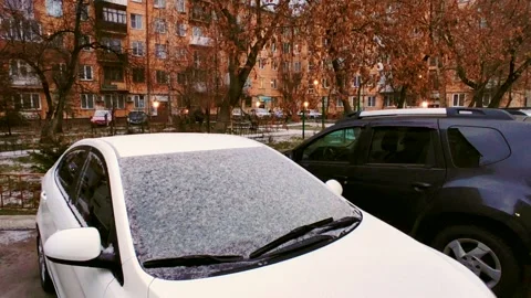 Light snow on the car and grass, yellow trees around Stock-Footage 220926643
