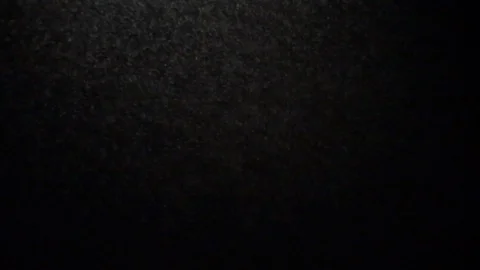 Light snow dancing in a spotlight at night Stock Footage 100609903