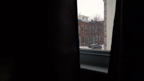 Light snow falling in city through window Stock Footage 102237083
