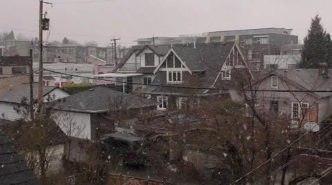 Light snow falling on residential rooftops in Vancouver, British Columbia Stock Footage 59110833