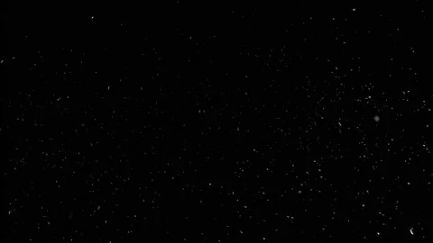 Light snow falling from the sky in complete darkness. Stock Footage 143932264