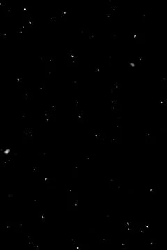 Light snowfall on black background, visual overlay layer for compositing Stock Photos