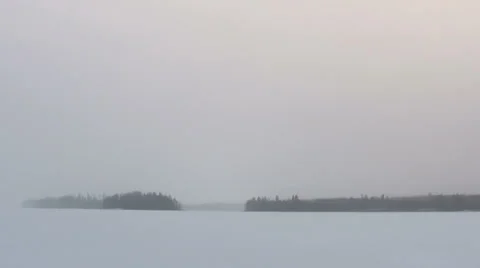 Light snowfall at a frozen lake Stock Footage 34269241