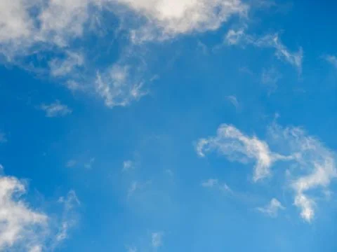 Light soft clouds against a bright blue sky Stock Photos