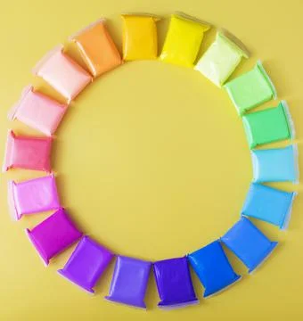 Light soft multi-colored plasticine is laid out in the form of a circle Stock Photos