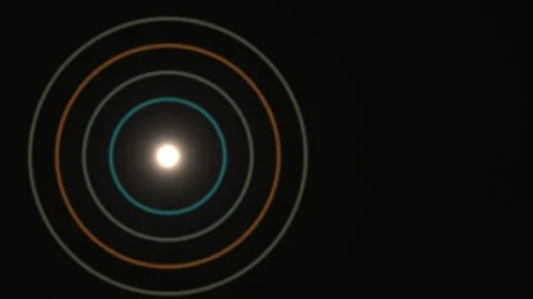 Light source with colored circles expanding in dark space Stock Footage 338295351