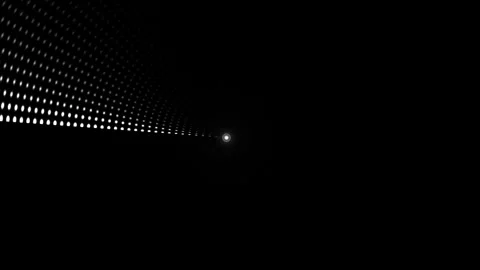 Light source shines through a dark tunnel with dot patterns Stock Footage 339304544