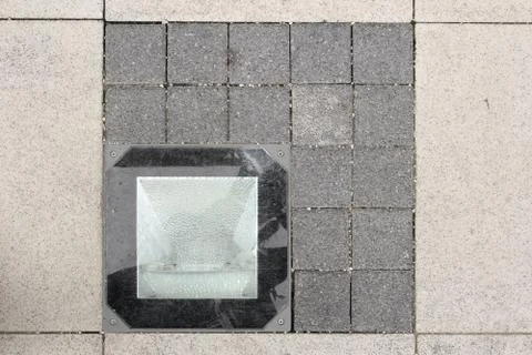 Light source on stone pavement, urban detail Stock Photos