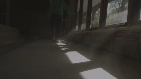 Light spills through the window as dust flies Stock Footage 146194245