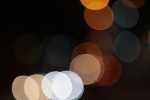 Light spots round multi-colored in the night on a dark background glow, shine Stock Photos