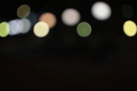 Light spots round multi-colored in the night on a dark background glow, shine Stock Photos