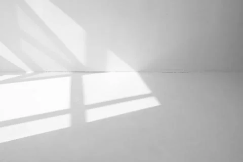 Light spots from the window on the white floor and wall Stock Photos