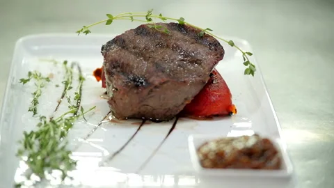 A Light Sprig of Thyme Complements the Meat Dish Stock Footage 132167424