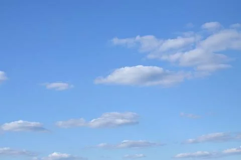 Light, spring clouds in the blue sky Stock Photos