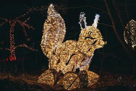 Light squirrel statue in Magical Botanic Garden exhibit in Warsaw Stock Photos