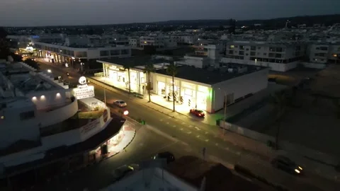 The light of the store at night and the movement of cars. Stock-Footage 166059851