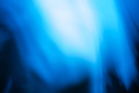 Light streaks create soft abstract pattern in shades of blue and purple. Bl.. Stockfoto's