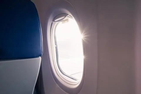 The light of the sun at the airplane window Stock Photos