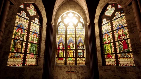 The light of the sun beaming in through the stained glass windows of a Church. Stock Footage 198150366