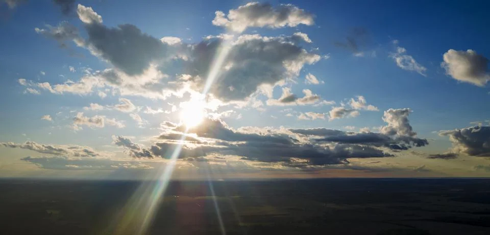 The light of the sun shining through the clouds in the sky. Amazing of fluffy Stock Photos