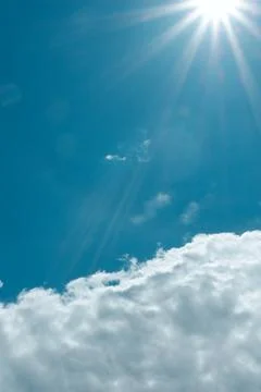 Light from sunbeams over white cloud against cyan blue sky. Vibrant seasona.. Stock Photos