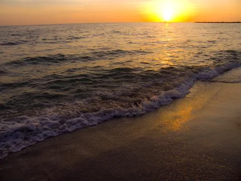 Light sunset rays falling on the waves Stock Photos